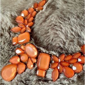 Coral/orange colored cluster bib statement necklace with gold chain